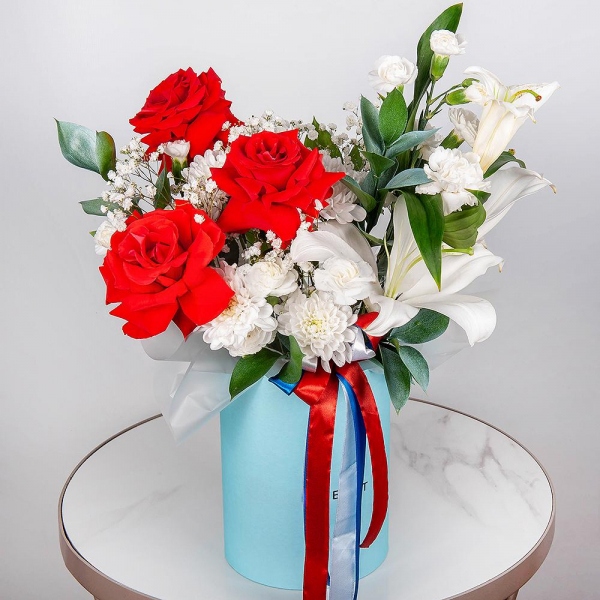 Red rose Nina 50 cm - 5, Gypsophila - 1, Baltica White Spray Chrysanthemum - 1, White spray carnation - 3, Carnation white, cream - 3, Lilies - 1, Round flower box medium, Oasis, Ruscus, Ribbon