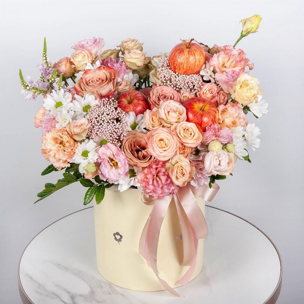 Bacardi White Spray Chrysanthemum - 2, Spray rose: white, cream, light pink 50 cm - 7, Роза Тоффи - 7, Pink Lisianthus (Eustoma) - 2, Round flower box medium, Oasis, Veronica spray, Ozotamnus, Pistachio,  Raspberry branch, Apple, 1 pc., Ribbon