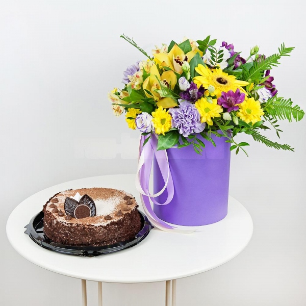 Gerbera yellow - 3, Lilac carnation - 3, Orchid bud yellow/brown Cymbidium - 3, Alstromeria Yellow, Orange - 2, Purple Lisianthus (Eustoma) - 7, Bacardi Yellow Spray Chrysanthemum - 3, Alstromeria lilac, purple - 2, Round flower box small , Film, Oasis, Pistachio, Ruscus, Ambrella, Flask for orchids, Ribbon, Cake in assortment