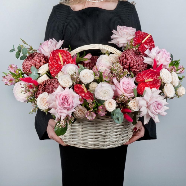 Red cut anthurium - 4, Chrysanthemum Bigoudi purple - 4, Peony style roses - 7, Ranunculus Pink - 5, Alstromeria white, soft pink - 19, Peony sprayrose - 5, Medium Basket, Oasis, Waxflower (1 pc.), Eucalyptus, Dried flowers in assortment