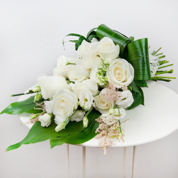 White rose 50 cm - 14, lisianthus - 6, Astilbe, Aspidistra (1 pc.), Ribbon