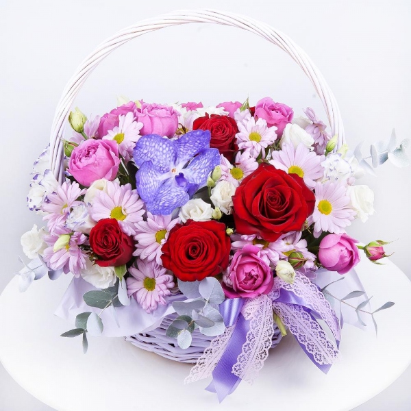 Vanda Orchid bud - 2, Bacardi Pink Spray Chrysanthemum - 3, Spray peony rose Misty Bubbles, 50 cm - 2, Purple Lisianthus (Eustoma) - 3, Red rose 50 cm - 6, Medium Basket, Oasis, Eucalyptus Cinerea, Flask for orchids, Aspidistra (1 pc.), Pistachio, Ribbon