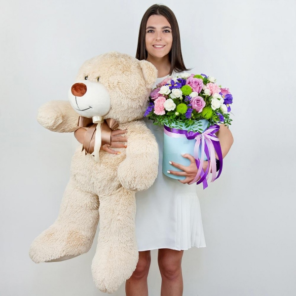 Deep Purple rose - 7, Spray rose: white, cream, light pink 50 cm - 10, Pink carnation - 4, Irises - 4, Athos pom Feeling Green - 3, Round flower box medium, Oasis, Film, Pistachio, Blue Statice, Teddy bear 70 cm, Ribbon