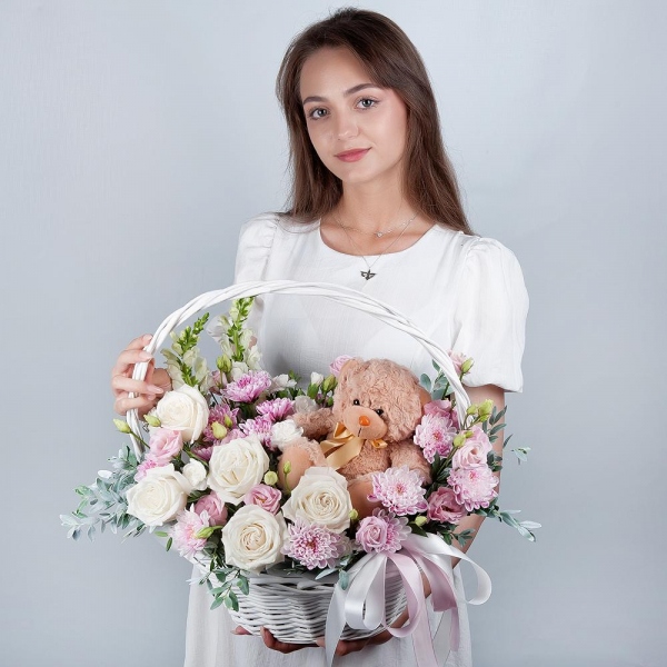White Matthiola - 2, White rose 50 cm - 7, Baltica Pink Spray Chrysanthemum - 3, White spray carnation - 3, Pink Lisianthus (Eustoma) - 2, Medium Basket, Oasis, Pistachio, Teddy bear 20 cm, Ribbon