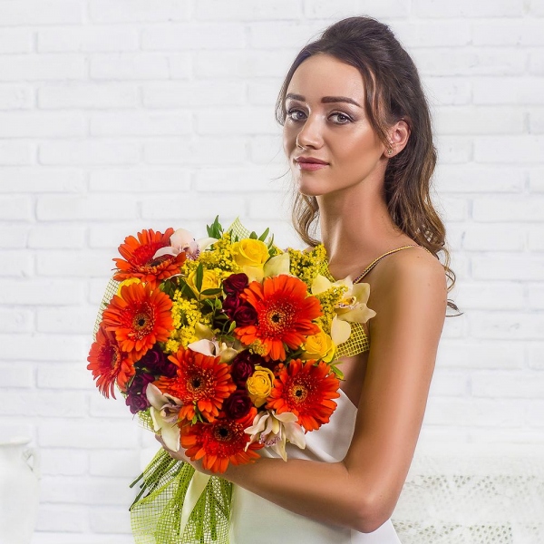Gerbera daisies - 7, Cymbidium Orchid bud - 7, Spray rose: red 50 cm - 5, Yellow rose 50 cm - 5, Flask for orchids, Solidago (1 pc.), Pistachio, Mesh (Abaka), Ribbon