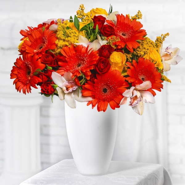 Gerbera daisies - 7, Cymbidium Orchid bud - 7, Spray rose: red 50 cm - 5, Yellow rose 50 cm - 5, Flask for orchids, Solidago (1 pc.), Pistachio, Mesh (Abaka), Ribbon