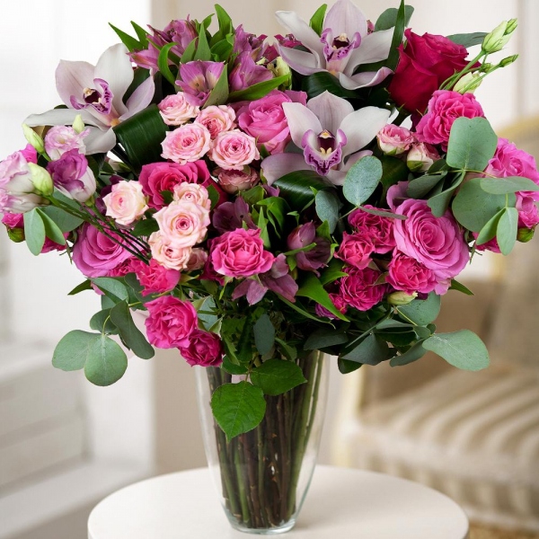 Pink rose 50 cm - 9, Pink Lisianthus (Eustoma) - 5, Alstromeria Red, Bright Pink - 4, Bright pink spray rose mix, 50 cm - 10, White Cymbidium Orchid Bud - 4, Eucalyptus Cinerea, Flask for orchids, Aspidistra (1 pc.), Wrapping Paper