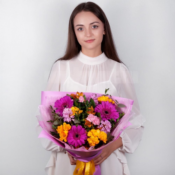 Purple gerbera - 5, Pink Hyacinth - 4, Alstromeria Yellow, Orange - 5, Pink spray carnation - 5, Freesia - 4, Pistachio, Eucalyptus, Wrapping Paper