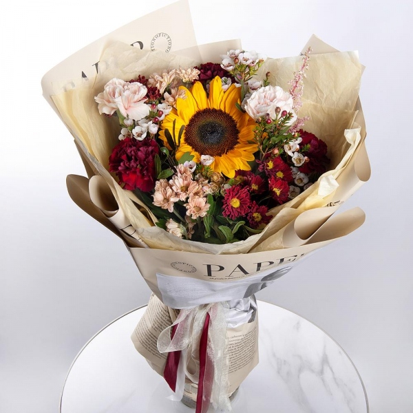 Sunflower - 1, Daisy poms Santini pink, purple - 6, Carnation red - 5, Carnation white, cream - 4, Waxflower (1 pc.), Astilbe, Pistachio, Wrapping Paper