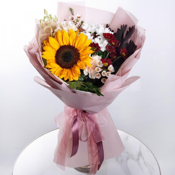 Sunflower - 1, Pink carnation - 5, Bacardi White Spray Chrysanthemum - 2, Bacardi Red Spray Chrysanthemum - 1, Astilbe, Waxflower (1 pc.), Pistachio, Salal, Wrapping Paper